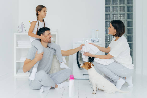 familia feliz poniendo la lavadora